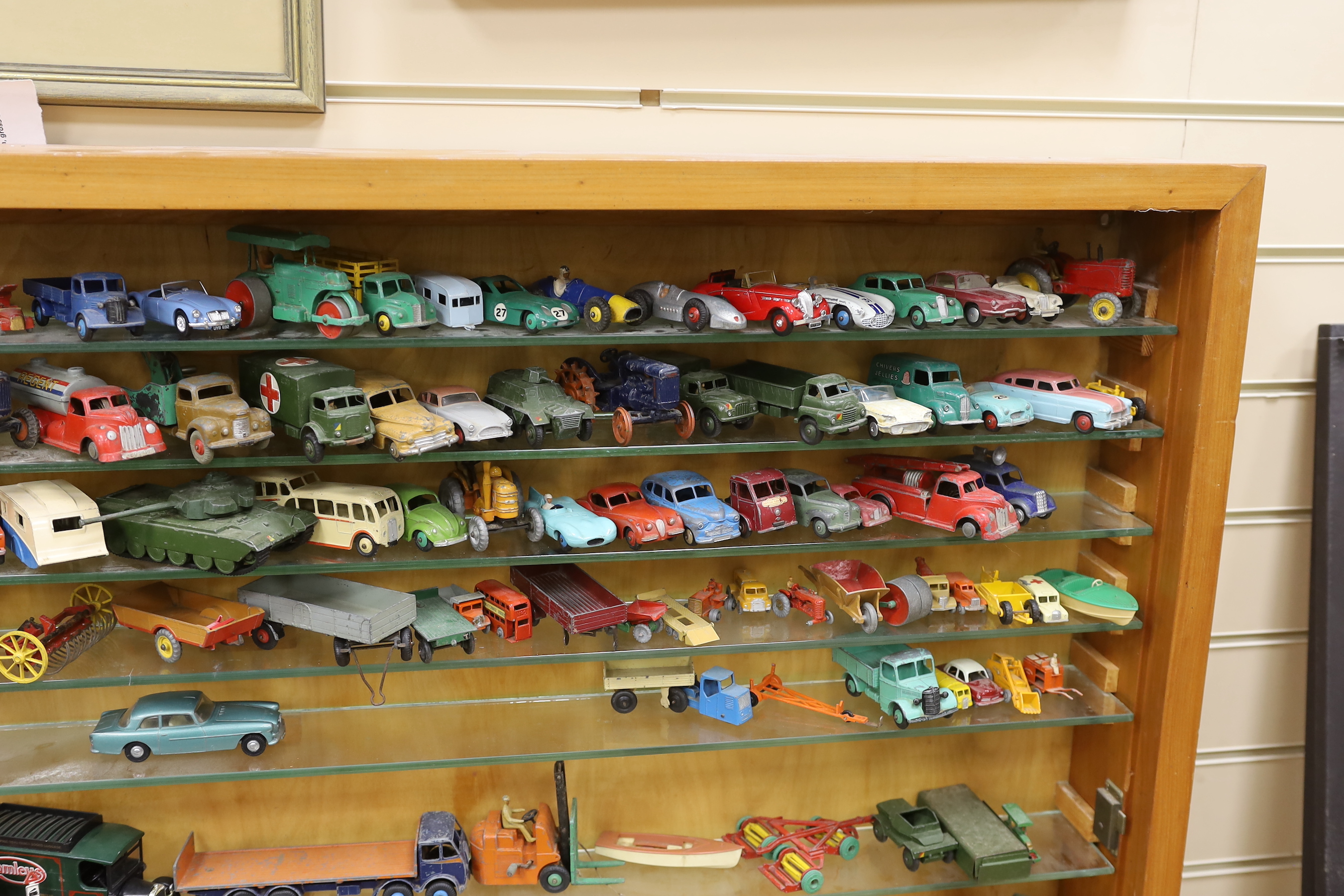 A collection of diecast vehicles in display case